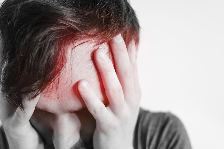 Man holding his head after concussion