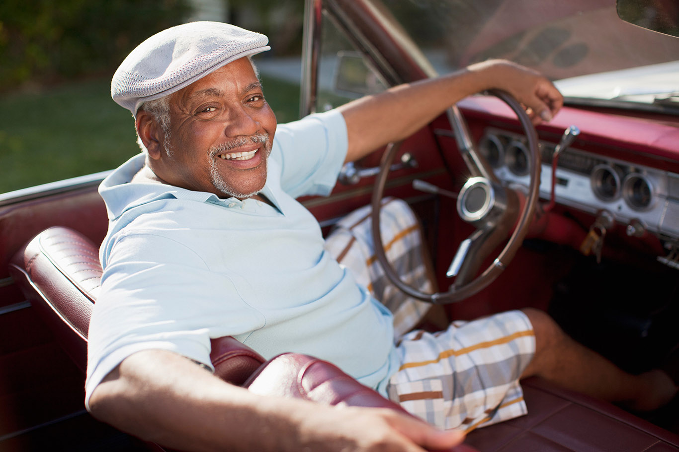 Smiling older man driving convertible in Boca Raton