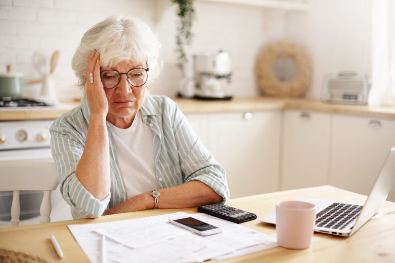 elder woman sad about money - pain and suffering - boca raton